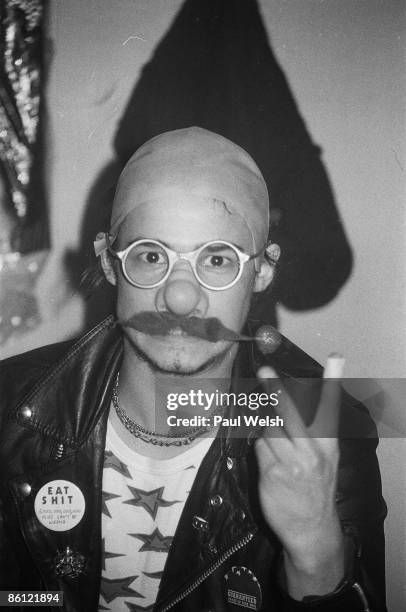 Photo of MOTORHEAD; Phil 'Philthy Animal' Taylor backstage at the Electric Circus, wearing bald wig and fake moustache, gesturing