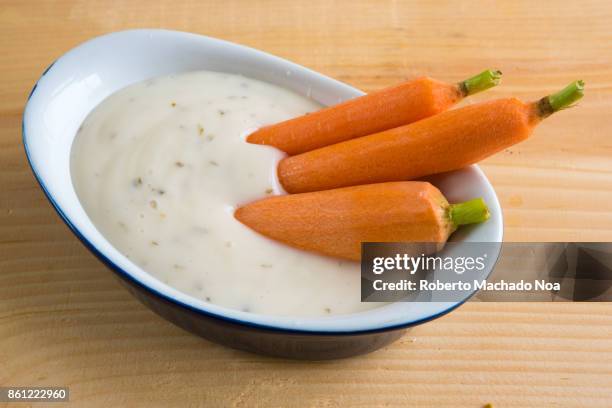 healthy eating: small raw carrots or natural baby carrots in a small recipient full of ranch dressing - ranch dressing stock pictures, royalty-free photos & images