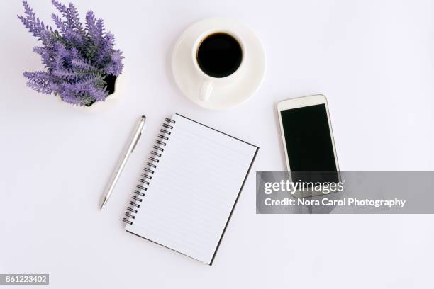 simple business table with mock up office supplies and smartphoneon white - notepad white table foto e immagini stock