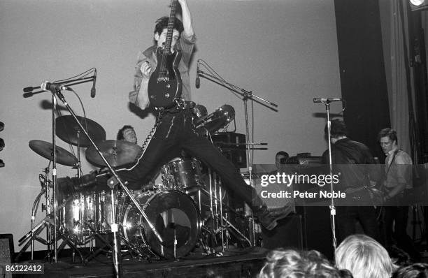 Photo of CLASH and Topper HEADON and Mick JONES and Joe STRUMMER and Paul SIMONON, Group performing on stage L-R Topper Headon, Mick Jones , Joe...