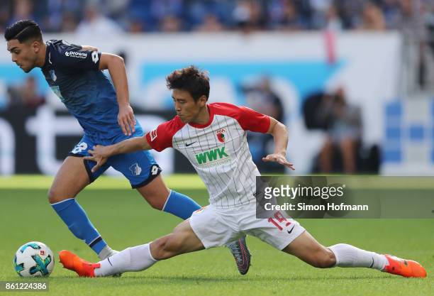 Nadiem Amiri of Hoffenheim fights for the ball with Koo Ja-cheol of Augsburg during the Bundesliga match between TSG 1899 Hoffenheim and FC Augsburg...