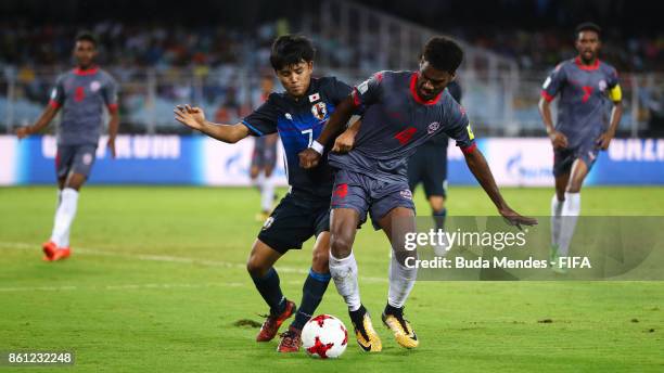 Takefusa Kubo of Japan battles for the ball with Kiam Wanesse of New Caledonia during the FIFA U-17 World Cup India 2017 group E match between Japan...