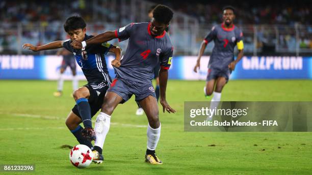 Takefusa Kubo of Japan battles for the ball with Kiam Wanesse of New Caledonia during the FIFA U-17 World Cup India 2017 group E match between Japan...