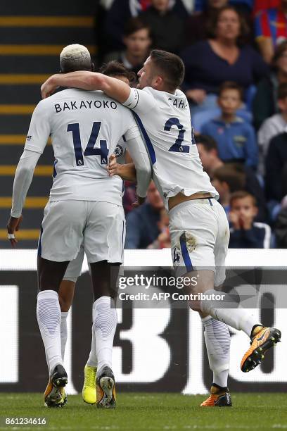 Chelsea's French midfielder Tiemoue Bakayoko celebrates with teammates after scoring their first goal during the English Premier League football...