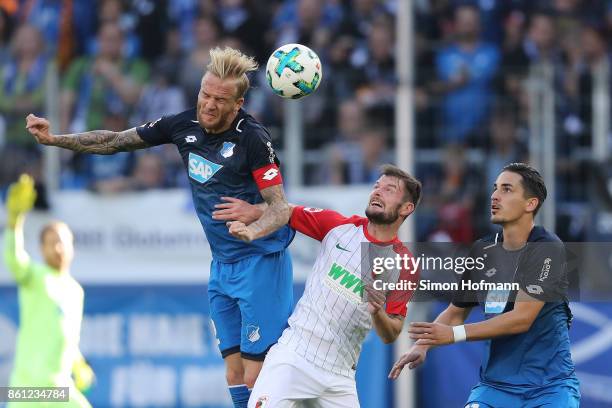 Kevin Vogt of Hoffenheim, Marcel Heller of Augsburg and Benjamin Huebner of Hoffenheim during the Bundesliga match between TSG 1899 Hoffenheim and FC...