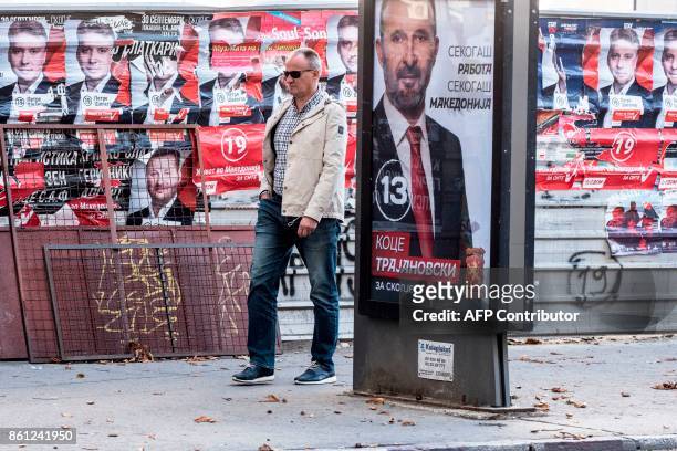 Man walks past electoral campaign billboard picturing the candidate of the conservative party Internal Macedonian Revolutionary Organization...