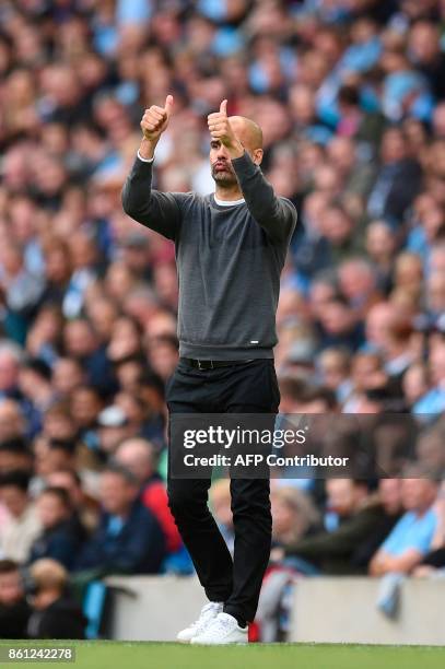 Manchester City's Spanish manager Pep Guardiola gestures a thumbs-up from the touchline during the English Premier League football match between...