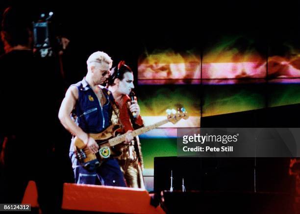 Photo of BONO and U2 and Adam CLAYTON, Adam Clayton & Bono performing live onstage dressed as Mister Macphisto character, wearing devil horns, on the...