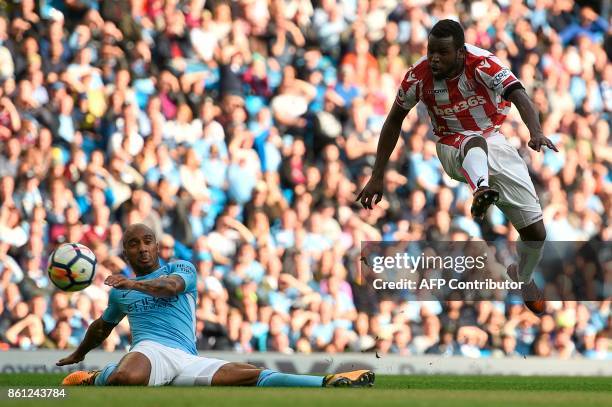 Stoke City's Senegalese striker Mame Biram Diouf scores their first goal during the English Premier League football match between Manchester City and...