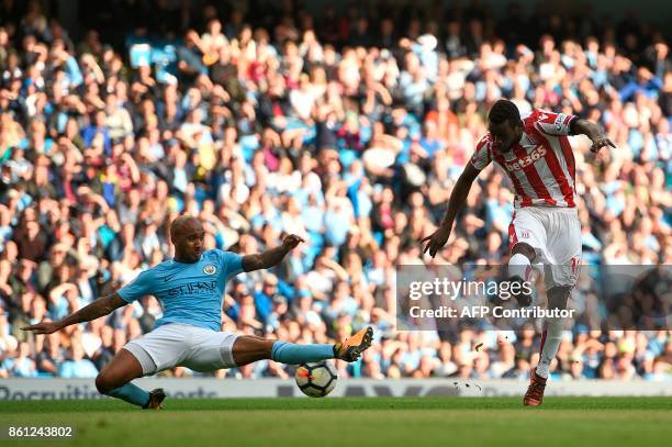 Stoke City's Senegalese striker Mame Biram Diouf scores their first goal during the English Premier League football match between Manchester City and...