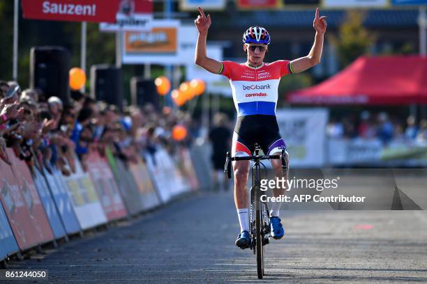 Dutch cyclist Mathieu Van Der Poel celebrates as he crosses the finish line to win the men's elite race at the 'Poldercross' cyclocross cycling race...