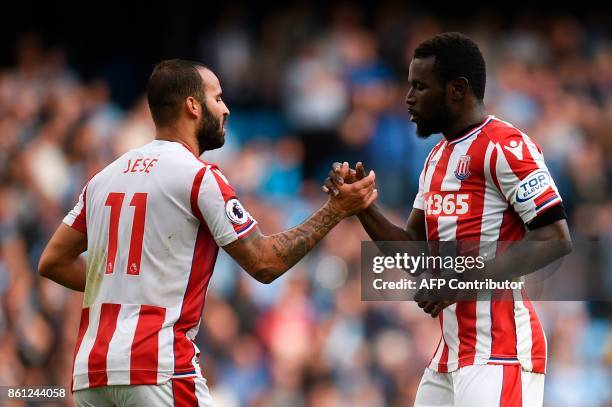 Stoke City's Senegalese striker Mame Biram Diouf celebrates scoring their first goal during the English Premier League football match between...