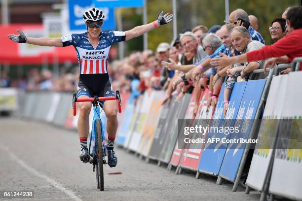 Katie Compton celebrates as she crosses the finish line to win the women's elite race at the 'Poldercross' cyclocross cycling race in Bazel,...