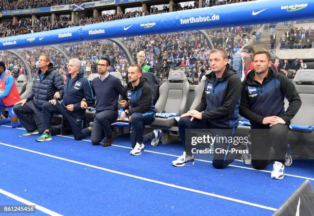 The substitutes' bench of Hertha BSC protest against Donald Trump #takeaknee before the game between Hertha BSC and Schalke 04 on october 14, 2017 in...