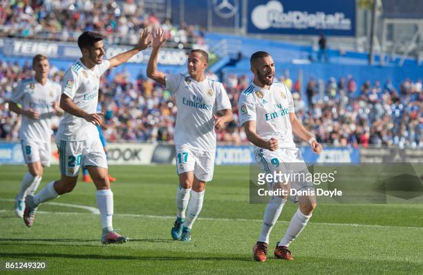 Karim Benzema of Real Madrid CF celebrates after scoring his team's opening goal during the La Liga match between Getafe and Real Madrid at Coliseum...