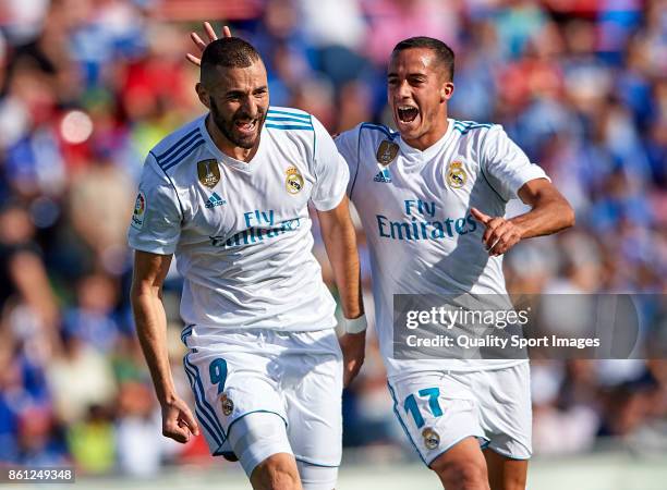 Karim Benzema of Real Madrid celebrates scoring his team's first goal with his teammate Lucas Vazquez during the La Liga match between Getafe and...