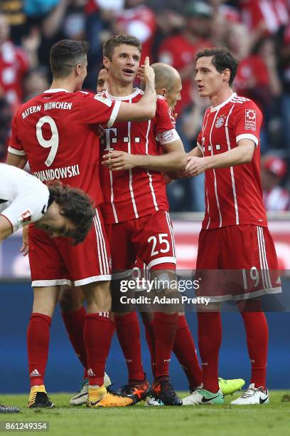 Robert Lewandowski of Bayern Muenchen celebrates scoring his teams fourth goal to make it 4:0 with Thomas Mueller of Bayern Muenchen and Sebastian...