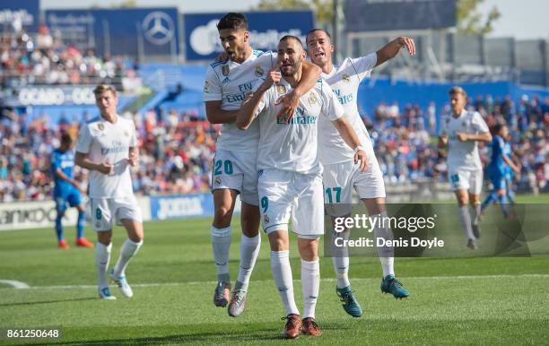 Karim Benzema of Real Madrid CF celebrates after scoring his team's opening goal during the La Liga match between Getafe and Real Madrid at Coliseum...