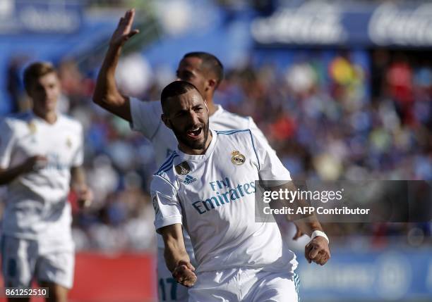 Real Madrid's French forward Karim Benzema celebrates after scoring a goal during the Spanish league football match Getafe CF vs Real Madrid at the...