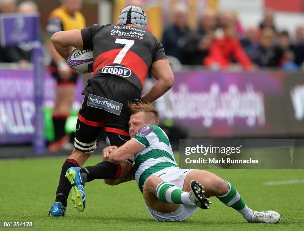 Sam Stuart of Newcastle Falcons tackles Ollie Griffiths of Dragons during the European Rugby Challenge Cup match between Newcastle Falcons and...