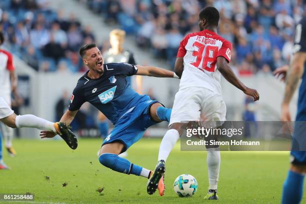 Sandro Wagner of Hoffenheim is being fouled by Caiuby of Augsburg during the Bundesliga match between TSG 1899 Hoffenheim and FC Augsburg at Wirsol...