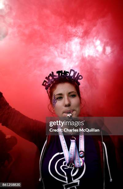 Ellie Evans, who has been questioned by police for holding a placard with the slogan 'Fuck the DUP' at a previous Gay Pride march wears a head dress...