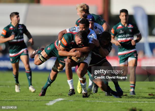 Mike Williams of Leicester is tackled by Teddy Thomas during the European Rugby Champions Cup match between Racing 92 and Leicester Tigers at Stade...