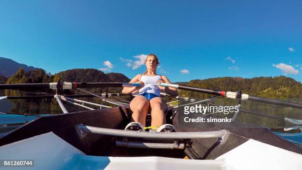 female athlete sculling on lake - sweep rowing stock pictures, royalty-free photos & images