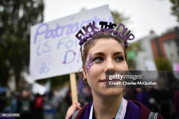 Ellie Evans, who has been questioned by police for holding a placard with the slogan 'Fuck the DUP' at a previous Gay Pride march wears a head dress...