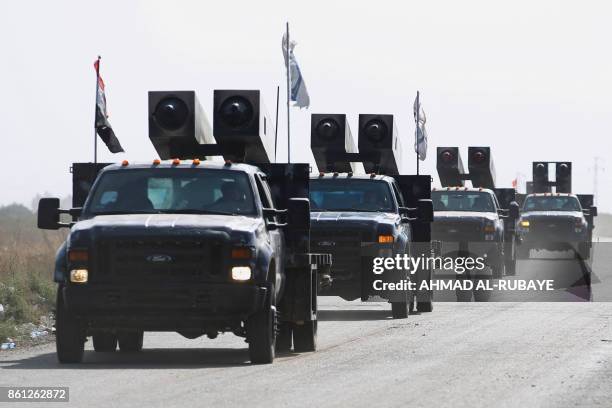 Iraqi forces drive towards Kurdish peshmerga positions on October 14 on the southern outskirts of Kirkuk. Thousands of Iraqi troops were locked in an...