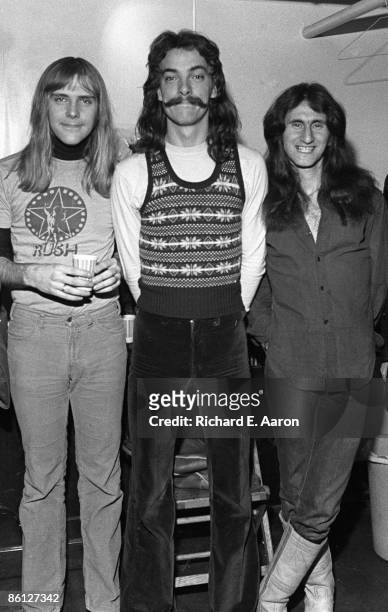 Photo of Neil PEART and RUSH and Alex LIFESON and Geddy LEE; L-R: Alex Lifeson, Neil Peart, Geddy Lee - posed, group shot, backstage at the Academy...