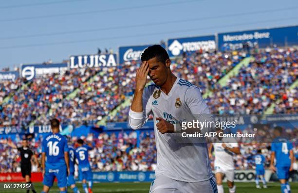 Real Madrid's Portuguese forward Cristiano Ronaldo crosses himself to celebrate his team's second goal during the Spanish league football match...