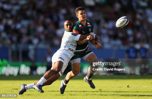 Matt Toomua of Leicester off loads the ball as Joe Rokococko tackles during the European Rugby Champions Cup match between Racing 92 and Leicester...