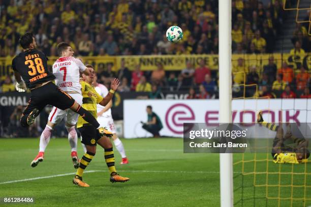 Marcel Sabitzer of Leipzig scores a goal past Roman Buerki of Dortmund to make it 1:1 during the Bundesliga match between Borussia Dortmund and RB...