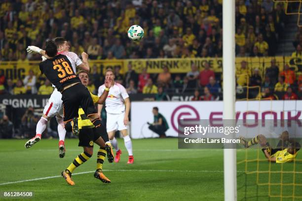 Marcel Sabitzer of Leipzig scores a goal past Roman Buerki of Dortmund to make it 1:1 during the Bundesliga match between Borussia Dortmund and RB...