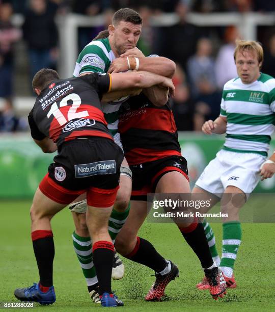 Mark Wilson of Newcastle Falcons is tackled by Adam Warren and George Gasson of Dragons in the second half during the European Rugby Challenge Cup...