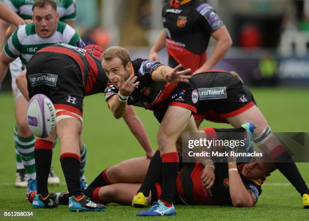 Sarel Pretorius of Dragons offloads the ball under pressure during the European Rugby Challenge Cup match between Newcastle Falcons and Dragons at...