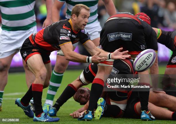 Sarel Pretorius of Dragons offloads the ball under pressure during the European Rugby Challenge Cup match between Newcastle Falcons and Dragons at...