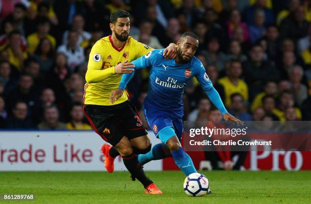 Miguel Britos of Watford chases down Alexandre Lacazette of Arsenal during the Premier League match between Watford and Arsenal at Vicarage Road on...