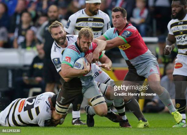 Chris Robshaw of Harlequins tackled by Hikairo Forbes of La Rochelle and Jason Eaton of La Rochelle during the European Rugby Champions Cup match...