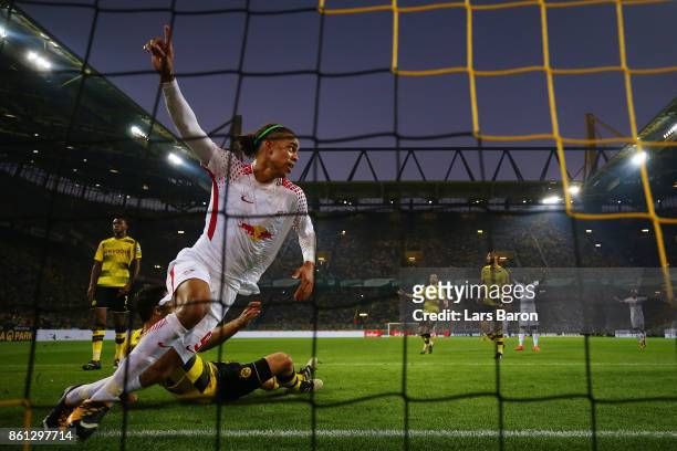 Yussuf Poulsen of Leipzig scores his teams second goal against Sokratis Papastathopoulos of Dortmund to make it 1:2 during the Bundesliga match...
