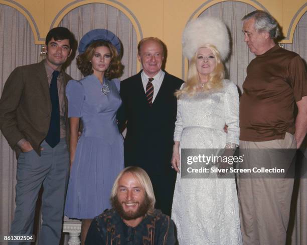 Portrait of, standing from left, American actor Rex Reed , actress Raquel Welch , producer Robert Fryer , actress Mae West , and actor John Huston ,...