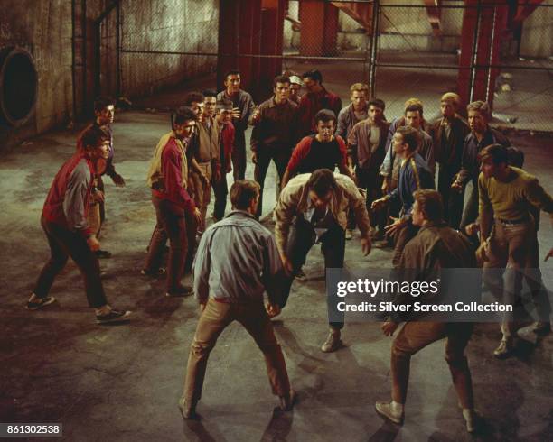 American actors George Chakiris , Richard Beymer , and Russ Tamblyn , along with other cast members, in a scene from 'West Side Story' , 1961.