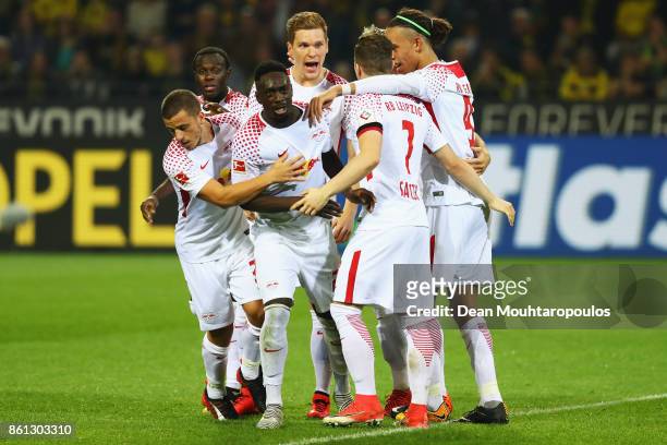 Jean-Kevin Augustin of RB Leipzig celebrates scoring his teams third goal of the game with team mates during the Bundesliga match between Borussia...