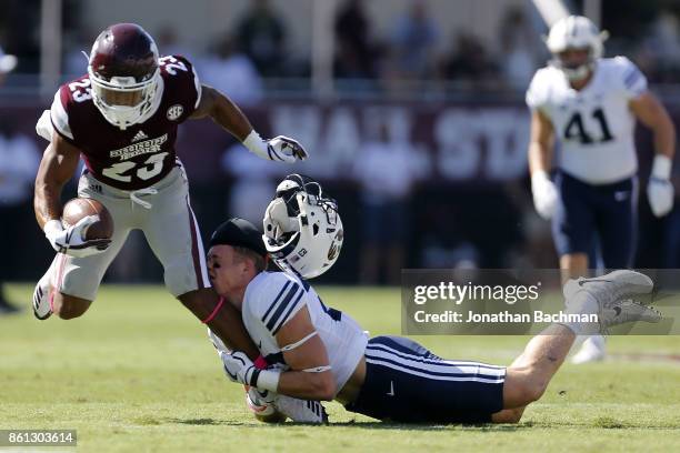 Zayne Anderson of the Brigham Young Cougars tackles Keith Mixon of the Mississippi State Bulldogs during the first half of a game at Davis Wade...