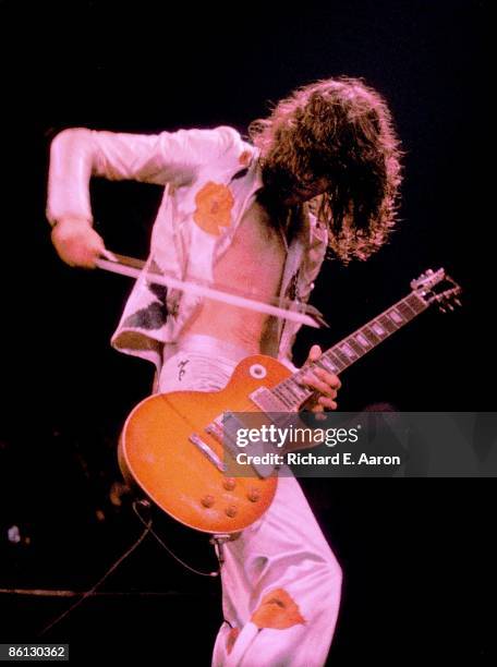 Photo of LED ZEPPELIN and Jimmy PAGE, Jimmy Page performing on stage, Gibson Les Paul guitar, violin bow