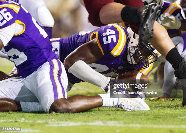 Tigers line backer Michael Divinity Jr. Recovers a fumble during a game between the LSU Tigers and Troy Trojans at Tiger Stadium in Baton Rouge,...