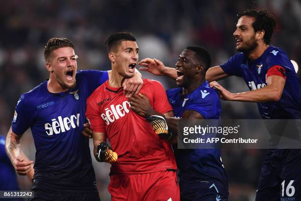 Lazio's goalkeeper Stefan Strakosha of Albania is congratulated by teammates after saving a penalty during the Italian Serie A football match...