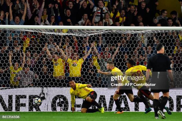 Watford's English mifielder Tom Cleverley celebrates after scoring a late winning goal during the English Premier League football match between...