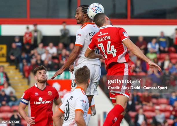 Blackpool's Nathan Delfouneso competes in the air with Walsall's James Wilson during the Sky Bet League One match between Walsall and Blackpool at...